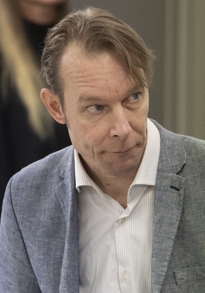 Christian Brueckner in a blue blazer and striped shirt, looking right.