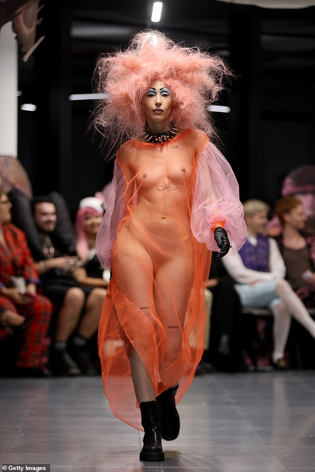 There were several other models present during the show including one who went braless in a sheer orange dress with pink sleeves and a black choker