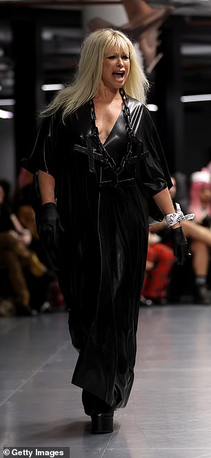 Jo Wood put on an animated display in a black leather dress with a v-neckline