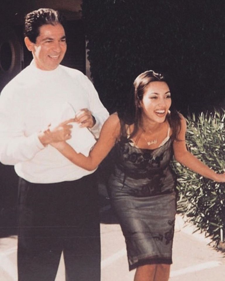 Kim Kardashian and her father Robert Kardashian laughing together.