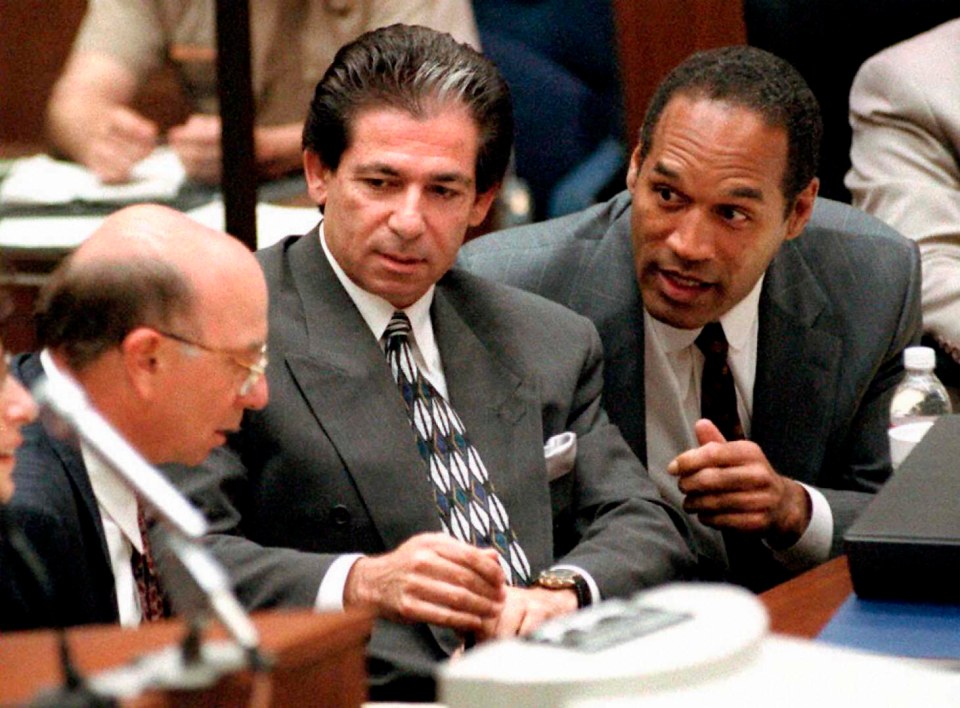 O.J. Simpson consulting with Robert Kardashian and Alvin Michelson in a courtroom.