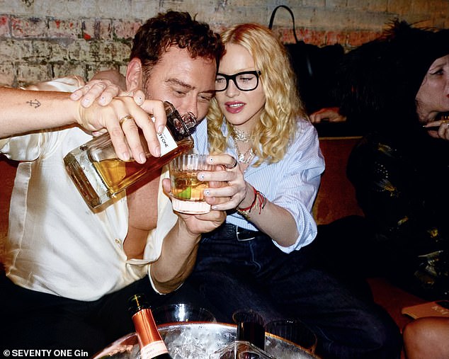 Meanwhile, Madonna cut a stylish figure in a blue striped shirt and dark denim jeans as her friend Mert poured her a bespoke Seventy One Gin creation