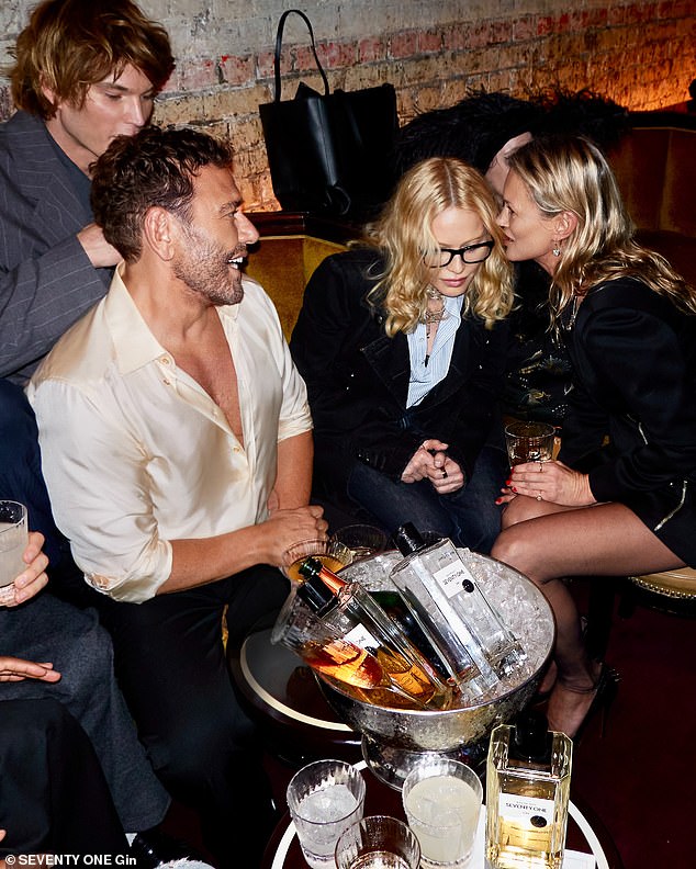 Kate, 51, looked effortlessly chic in a little black dress teamed with sheer tights and heels as she took her place at a VIP table with Jordan Barrett, Mert Alas, and Madonna (L-R)