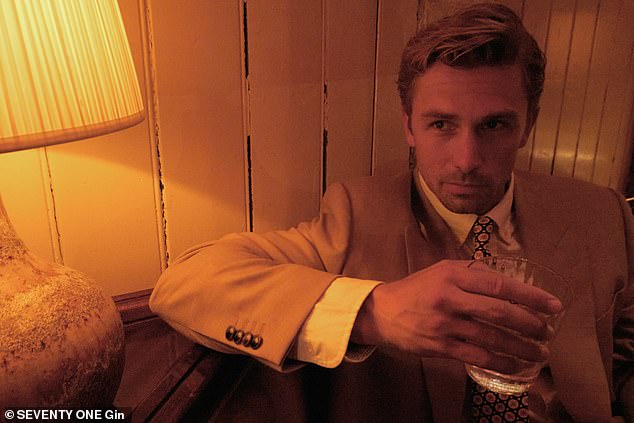 Model James turned heads in a sharp beige suit, striking a pose for the camera with his drink