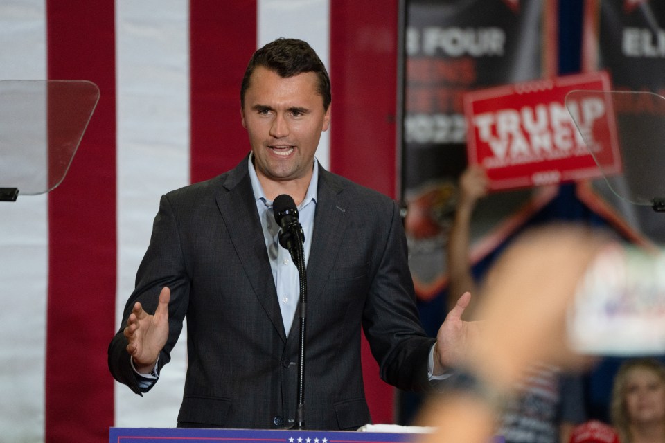 Charlie Kirk addressing a crowd at a political rally.