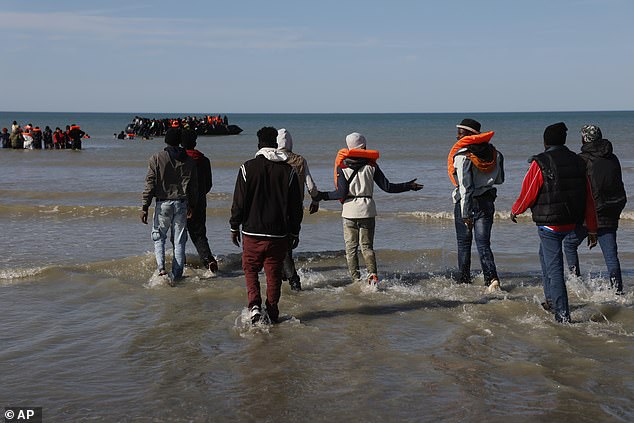 Migrants try to board a small boat to reach Britain, in Gravelines, northern France, Friday, Sept. 19, 2025