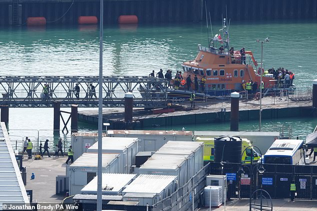 A group of people thought to be migrants are brought in to the Border Force compound in Dover, Kent, from an RNLI vessel following a small boat incident in the Channel on Friday