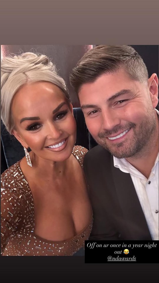 Jennifer Ellison and a man smiling while attending the NDA awards.