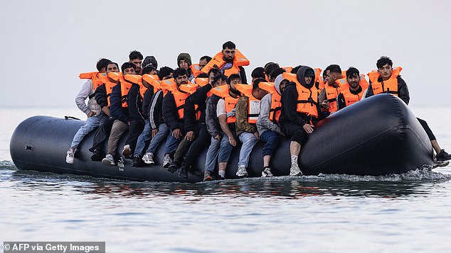 A smugglers¿ taxi boat in the Channel is overloaded with migrants wearing lifejackets