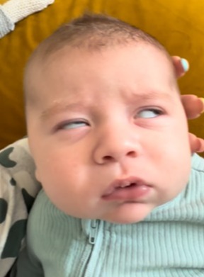 Photo of baby Jack Thomas with his eyes rolled back.