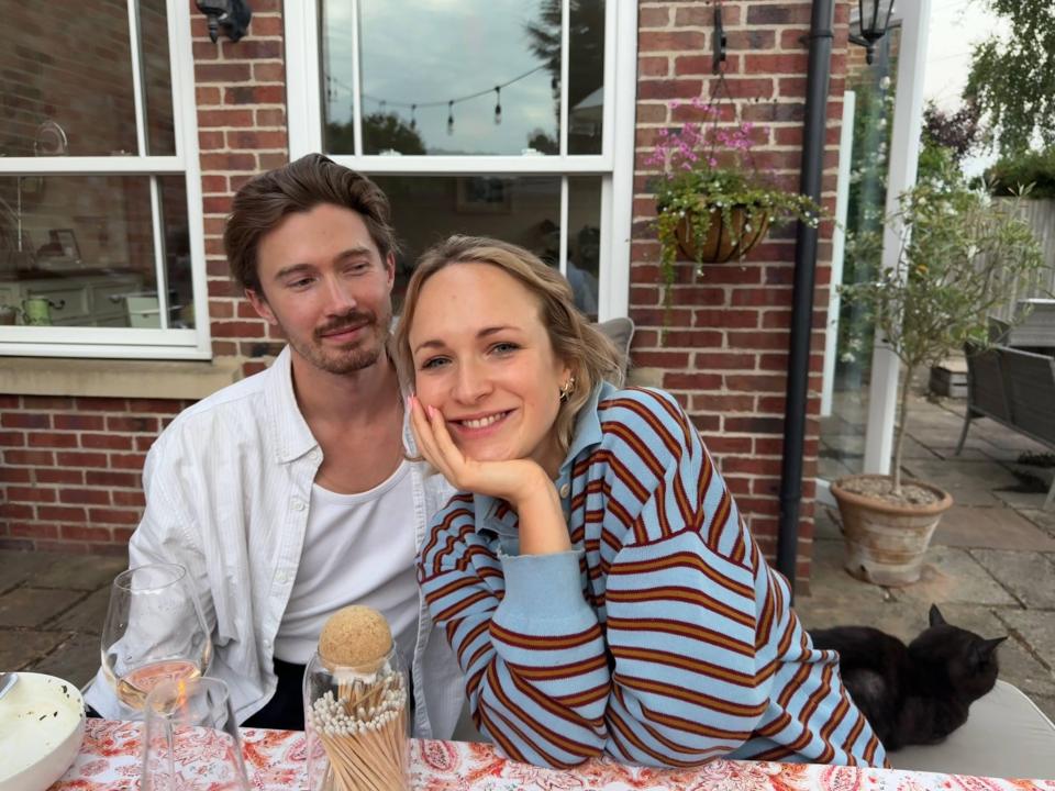 Seb and Ella sitting at an outdoor table.