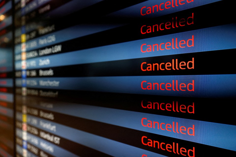 Departure panel shows flights as "Cancelled" due to strikes by airport employees.