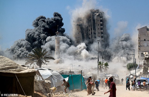 Palestinians run as the 15-storey Mushtaha Tower collapses after being hit by an Israeli air strike, in Gaza City, September 5, 2025