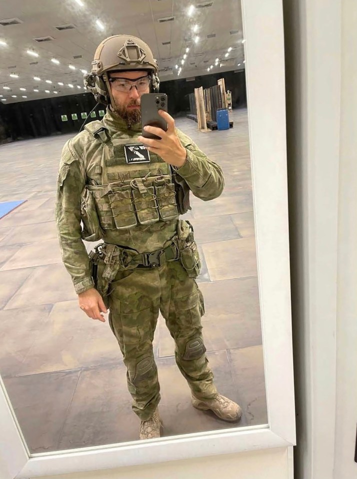 Jan Marsalek taking a selfie in military gear, wearing a helmet, safety glasses, and a tactical vest with a 'Z' patch.