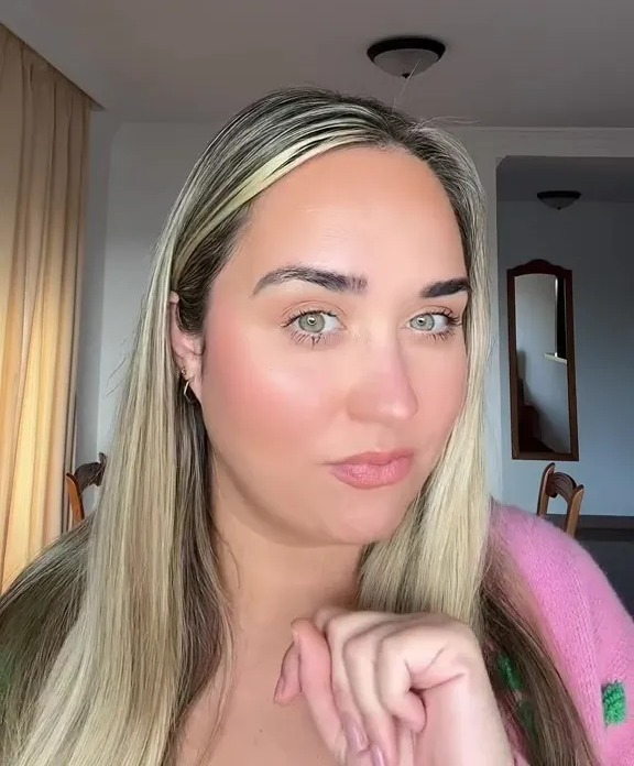 A woman with blonde hair and a pink top, named Georgina.