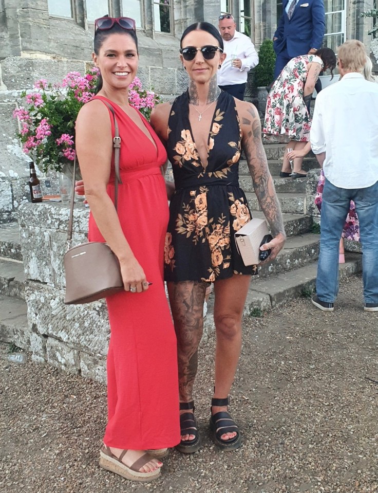 Two women in dresses posing for a photo.
