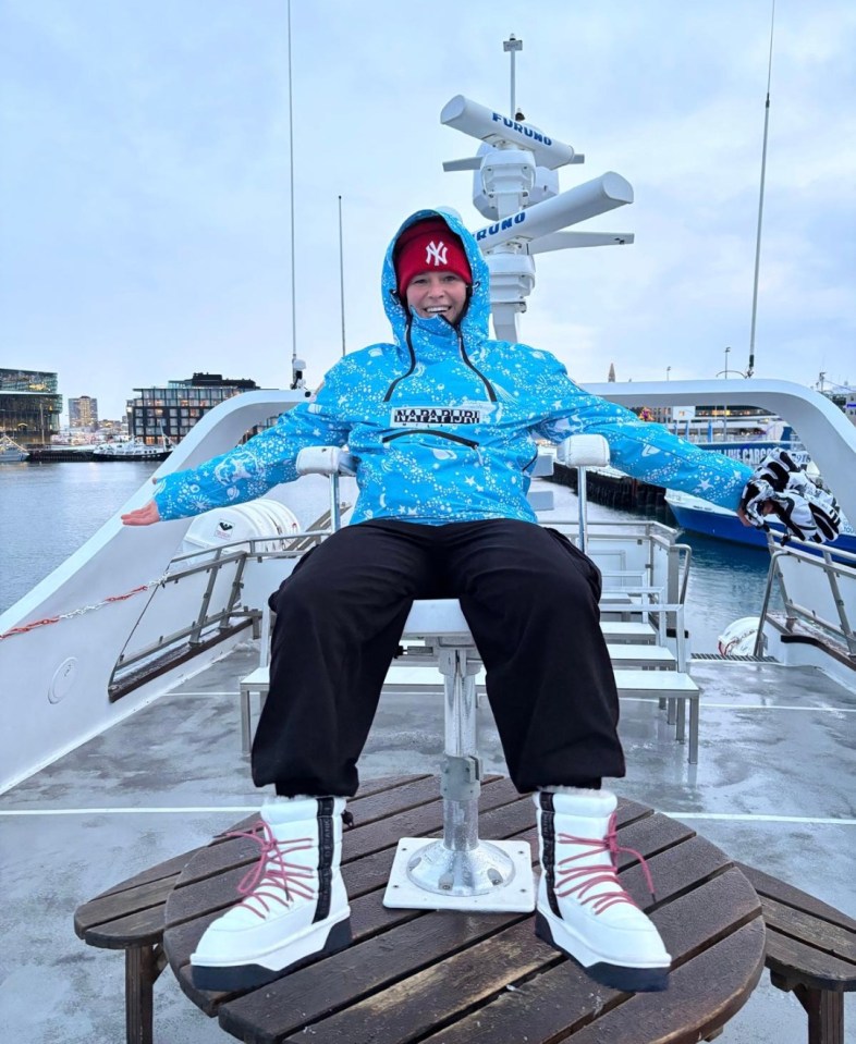 Person sitting on a boat deck.