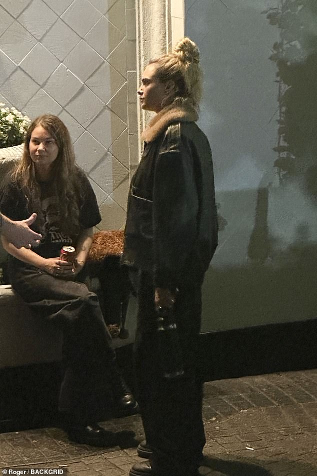 The model wore an aviator jacket and cargo trousers which she teamed with a graphic T-shirt