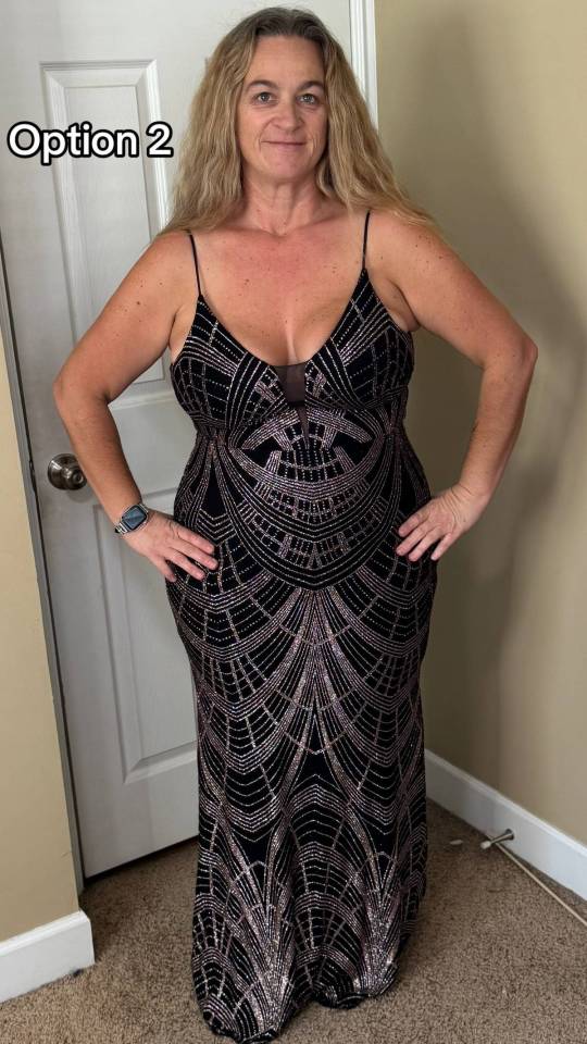 A woman in a black and gold sequined dress with thin straps and a plunging neckline.