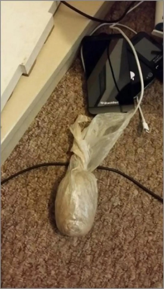 A bag of crack cocaine and heroin on a carpet.