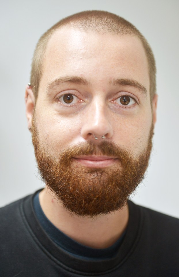 Headshot of Alex Clark from Callington, Cornwall, with a red beard, shaved head, and nose and ear piercings.