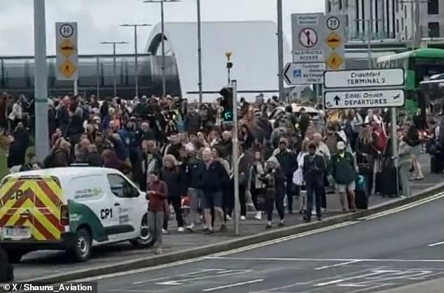 An 'extreme security alert' was raised after the suspected devices were discovered in the passenger's bag, senior security sources have claimed. The passenger was travelling to JFK Airport on a flight from London Heathrow via Ireland. Pictured: crowds outside of the airport