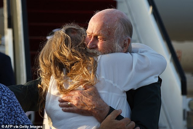 Peter Reynolds hugs his daughter Sarah Entwistle after landing at the airport in Doha on September 19, 2025
