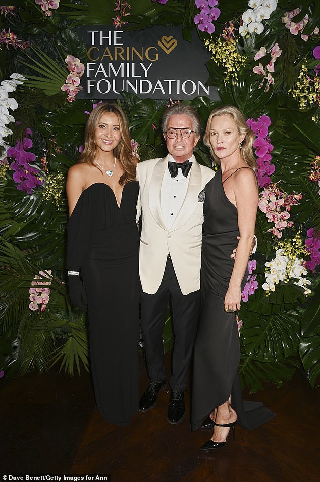 The supermodel, 51, cut a glamorous figure in a black silk gown featuring an asymmetric neckline, flattering ruched detailing at the waist, and a short train as she joined the couple for snaps (L-R Patricia, Richard, and Kate)