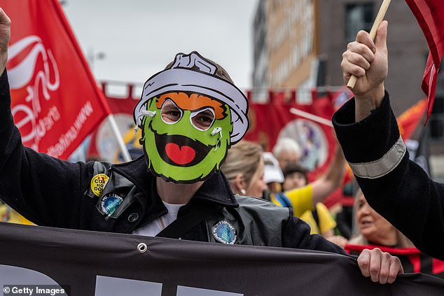 Many among the crowds donned Oscar the Grouch masks as they chanted through the streets