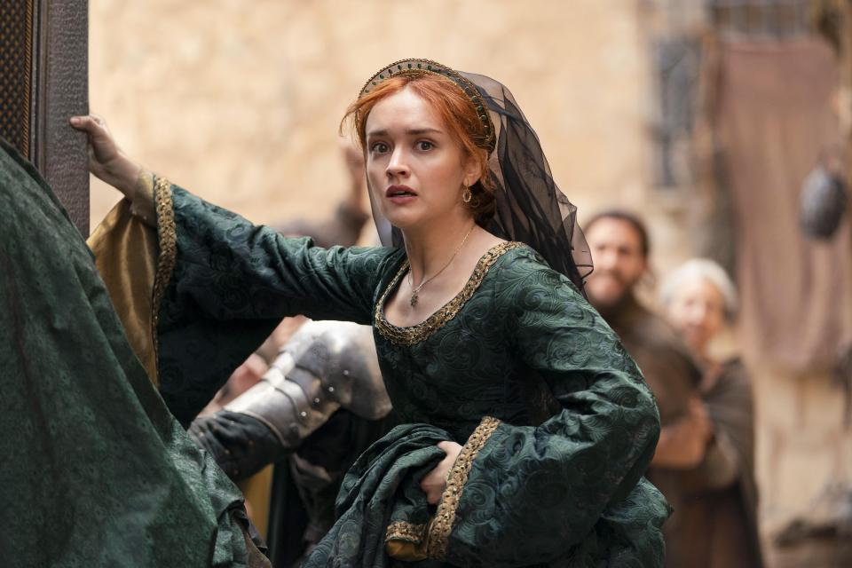 Olivia Cooke as Alicent Hightower in HBO's House of the Dragon, Season 2, looking scared with her hands on a door frame.