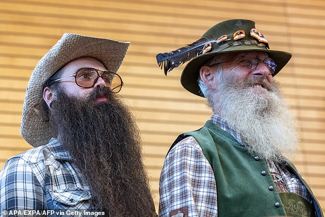 Two men go face to face as they show off their long beards at the gym in Leogang