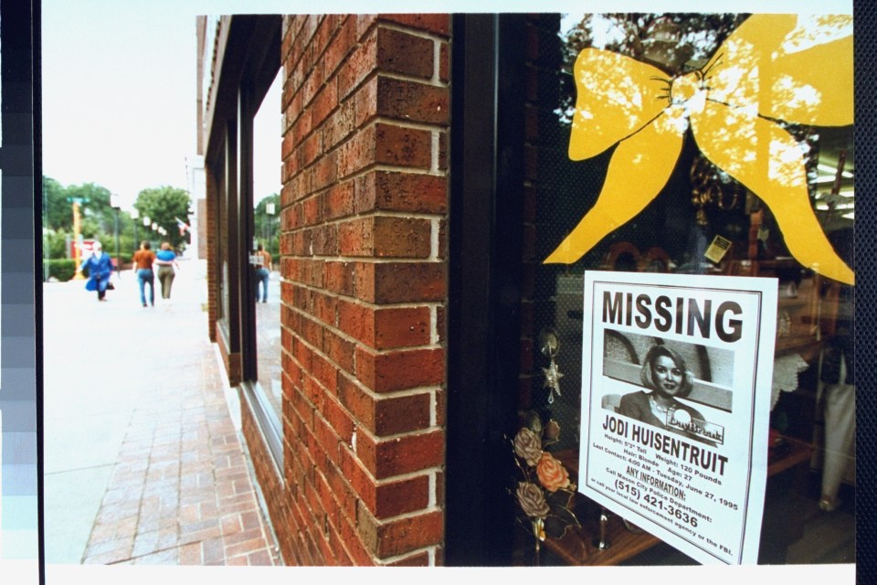 Storefront window with a flyer for missing Jodi Huisentruit.