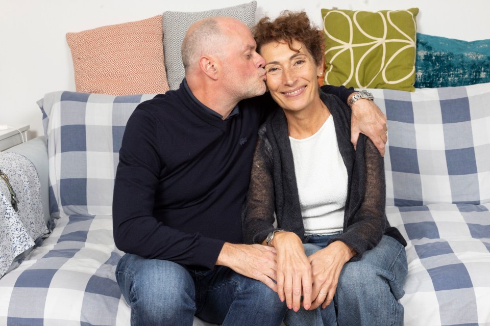 Mark Redmond kissing his wife Valentina on the cheek.