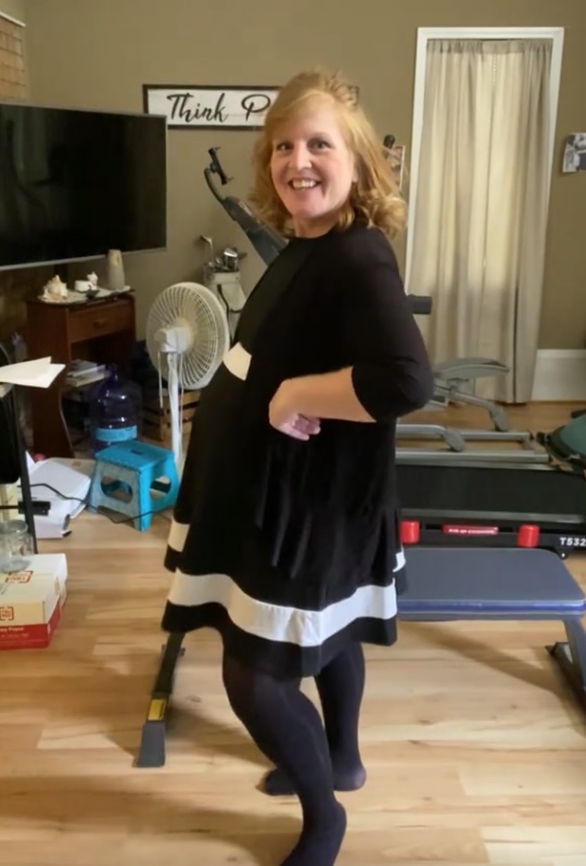 A pregnant woman in a black and white dress.