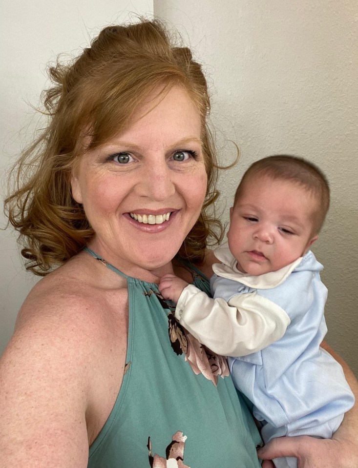 A woman holding her newborn baby.