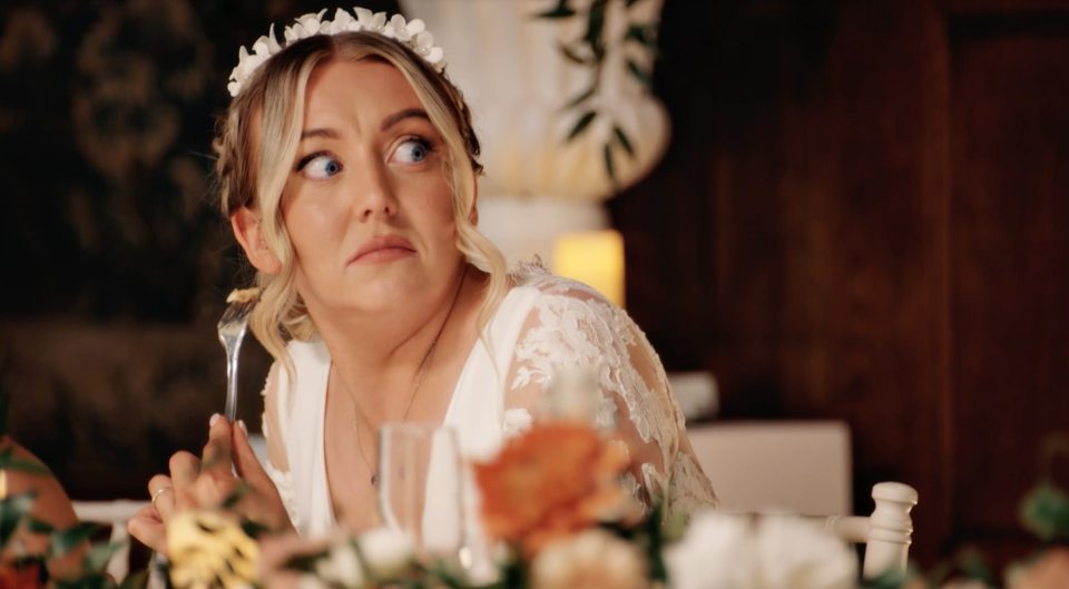 Bride looking unimpressed at wedding reception.