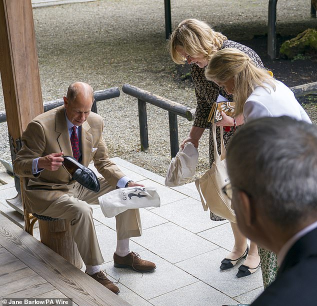 Edward and Sophie were photographed changing their shoes before entering the inner sanctum of the temple out of respect for the religious building