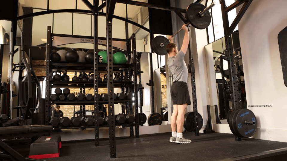 Man lifting weights in a gym.