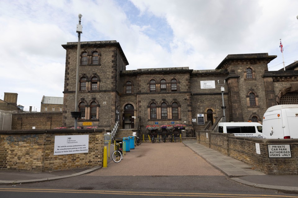 Exterior of HM Prison Wandsworth, with a sign indicating a "No drones zone" and "No vehicle access pedestrians only."