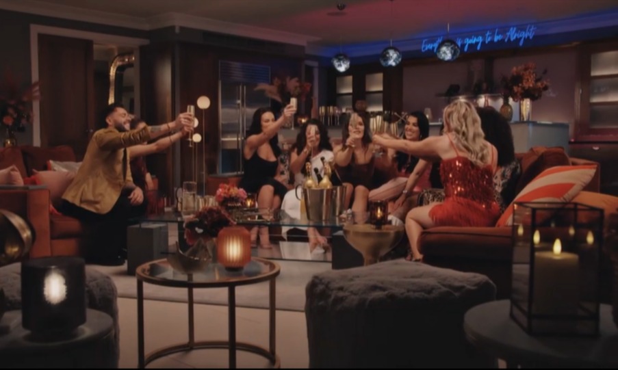 Several people raising champagne glasses in a toast.