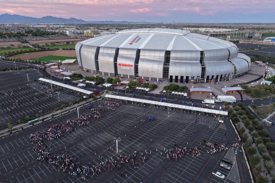 Drone view of people queueing to attend a memorial service at State Farm Stadium.