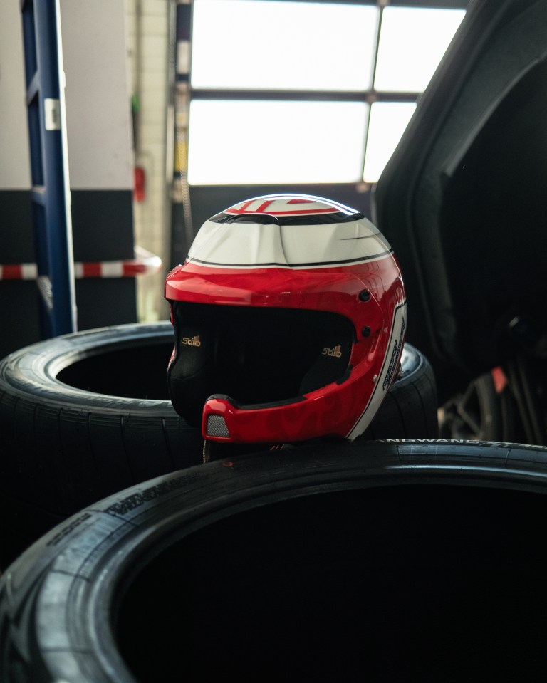 Red and white racing helmet on a stack of tires.