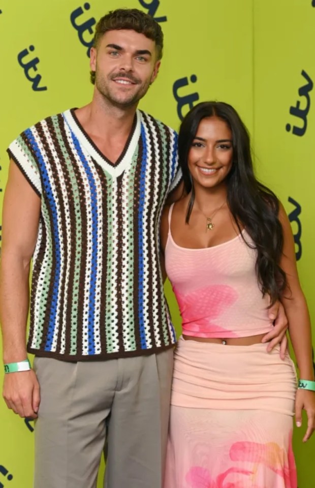 A smiling man and woman posing for a photo.