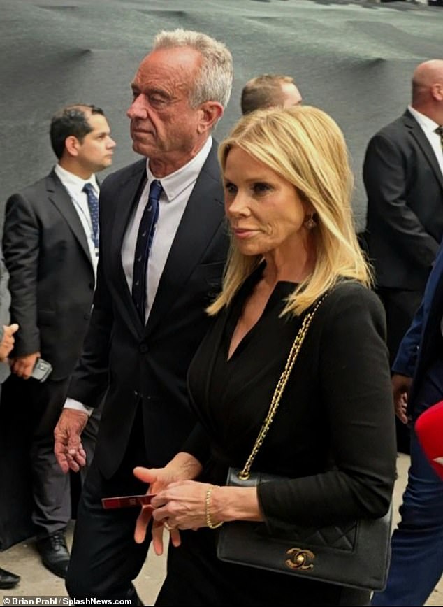 Robert F.Kennedy Jr. and Cheryl Hines walk into the stadium for Charlie Kirk's memorial service