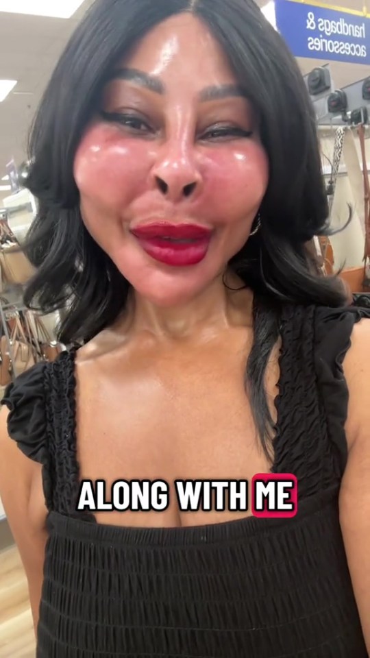 A woman with black hair, plumped cheeks, and red lips, wearing a black top, has text on her chest that says "ALONG WITH ME".