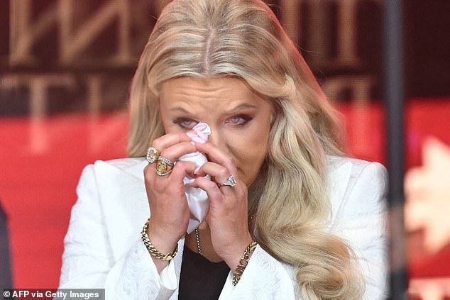 Charlie Kirk's widow Erika wipes a tear as she takes the stage at his memorial service