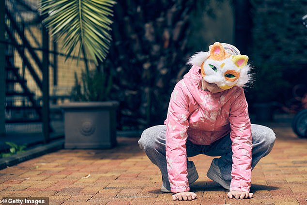 A file photos of a girl in a cat mask squatting as she does Quadrobics