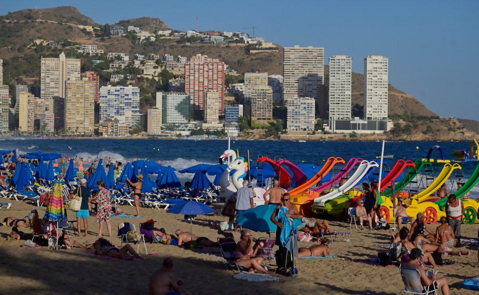 People enjoy the Levante Beach in Benidorm, north of Alicante, on September 10, 2025. (Photo by Jose Jordan / AFP) (Photo by JOSE JORDAN/AFP via Getty Images)