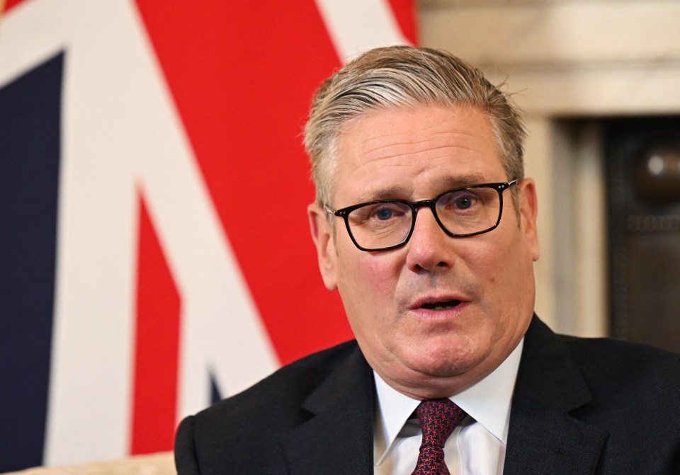 Keir Starmer sitting in front of a Union flag.