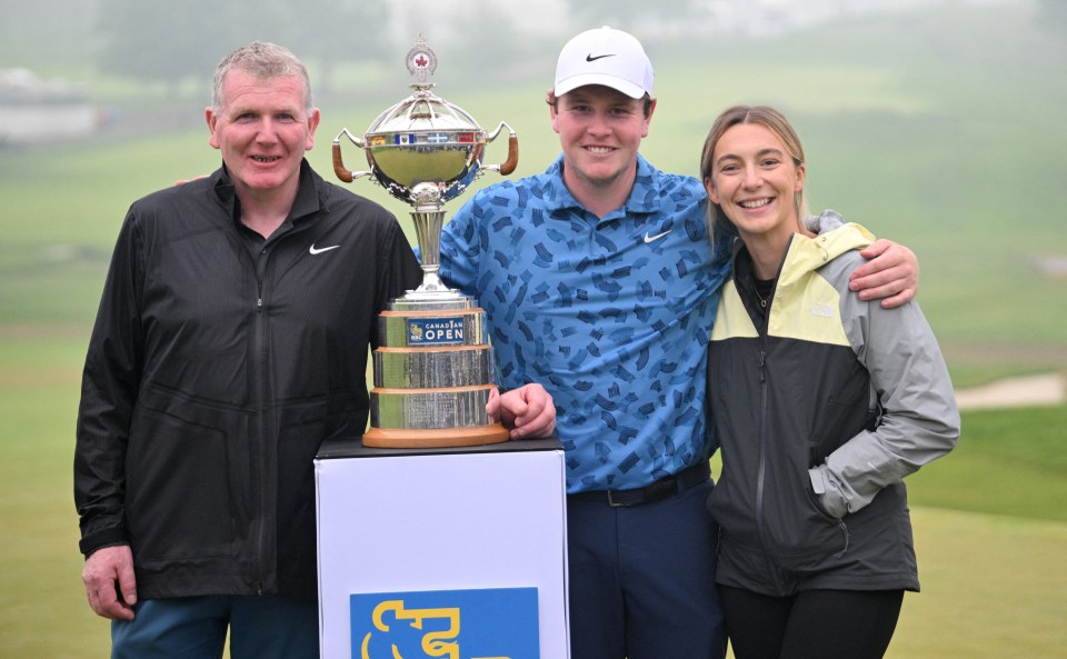 Robert MacIntyre, his father Dougie, and his girlfriend Shannon Hartley pose with the RBC Canadian Open trophy.